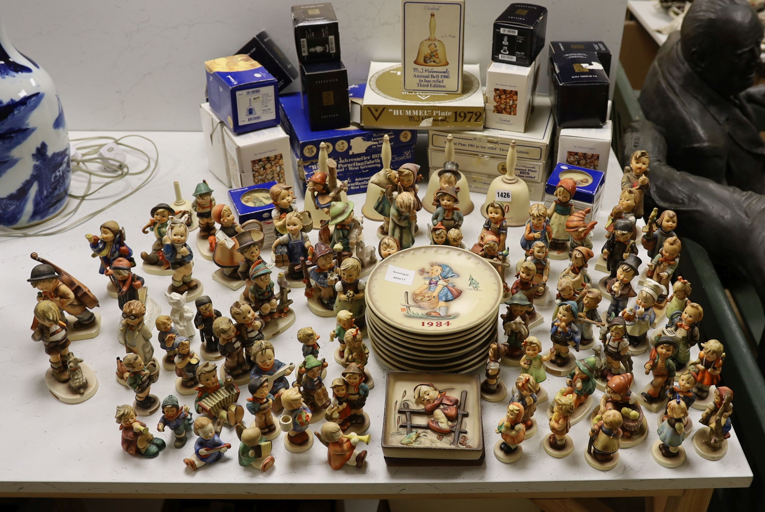 A large collection of Hummel pottery figures, approximately 70 including skier and two similar plaques, some with boxes.